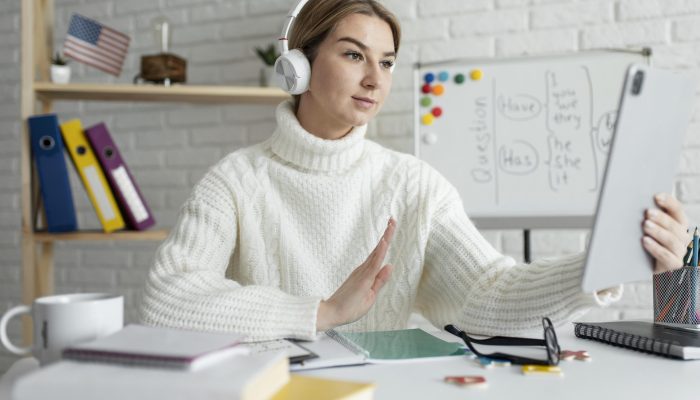 young-woman-teaching-kids-english-lesson-online